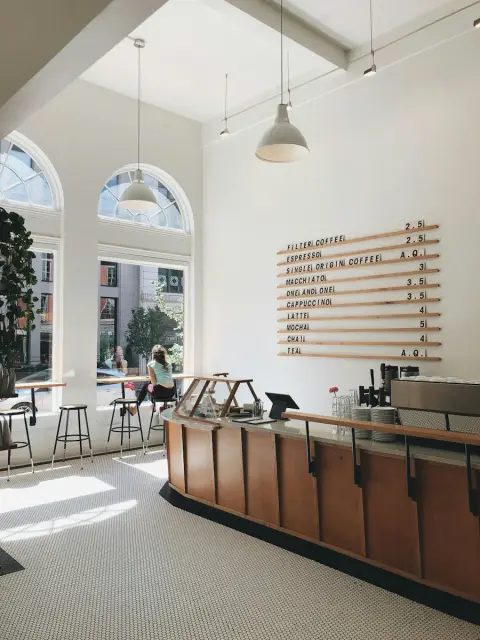 A small café with a wooden counter and coffee machine
