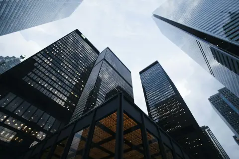 Tall glass office towers seen from the street
